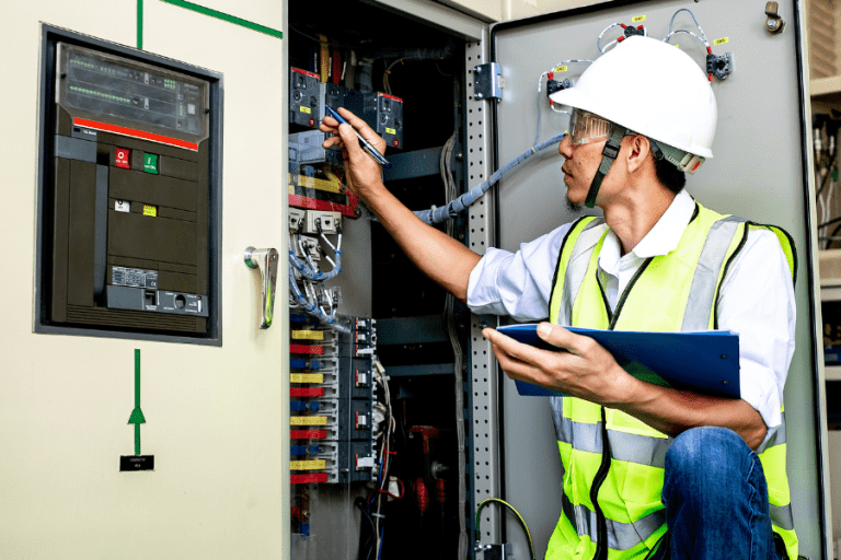 man conducting electrical safety inspections on commercial equipment